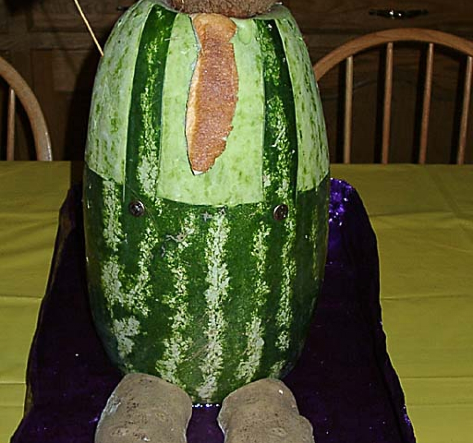 Watermelon carved to be Father of the Bride, with coconut head and potato feet