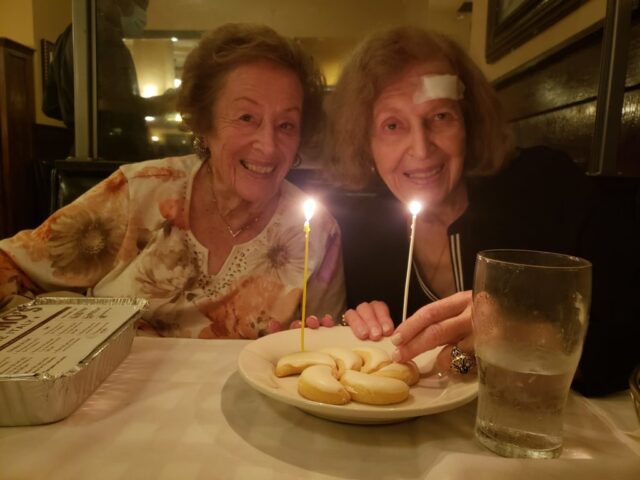 Leah's sister, Esther, and Leah with birthday candles and cookies