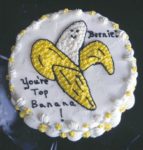 Partially peeled banana with smiling face and words "You're Top Banana"