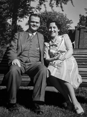 Black and white photo of Moses and Anne Mayov seated on a park bench