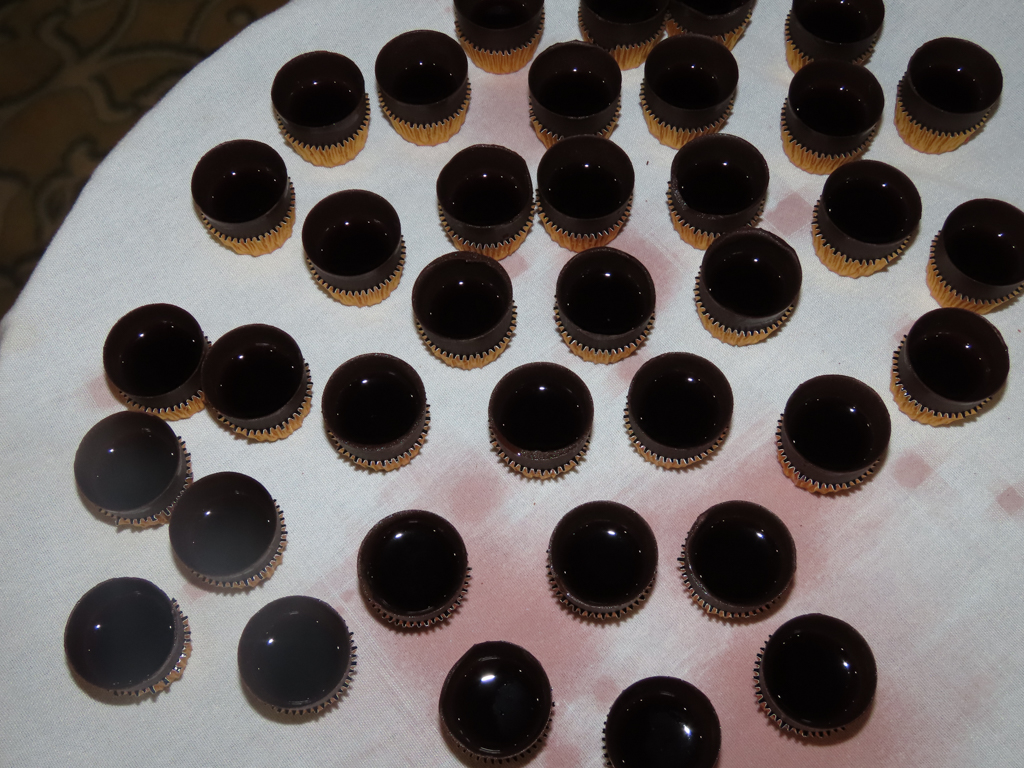 Tray of small chocolate cups containing cherry liqueur