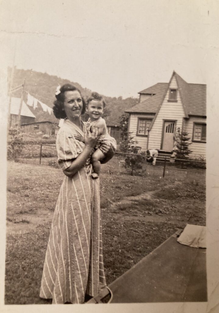 Woman wearing a long dress holding her very young daughter