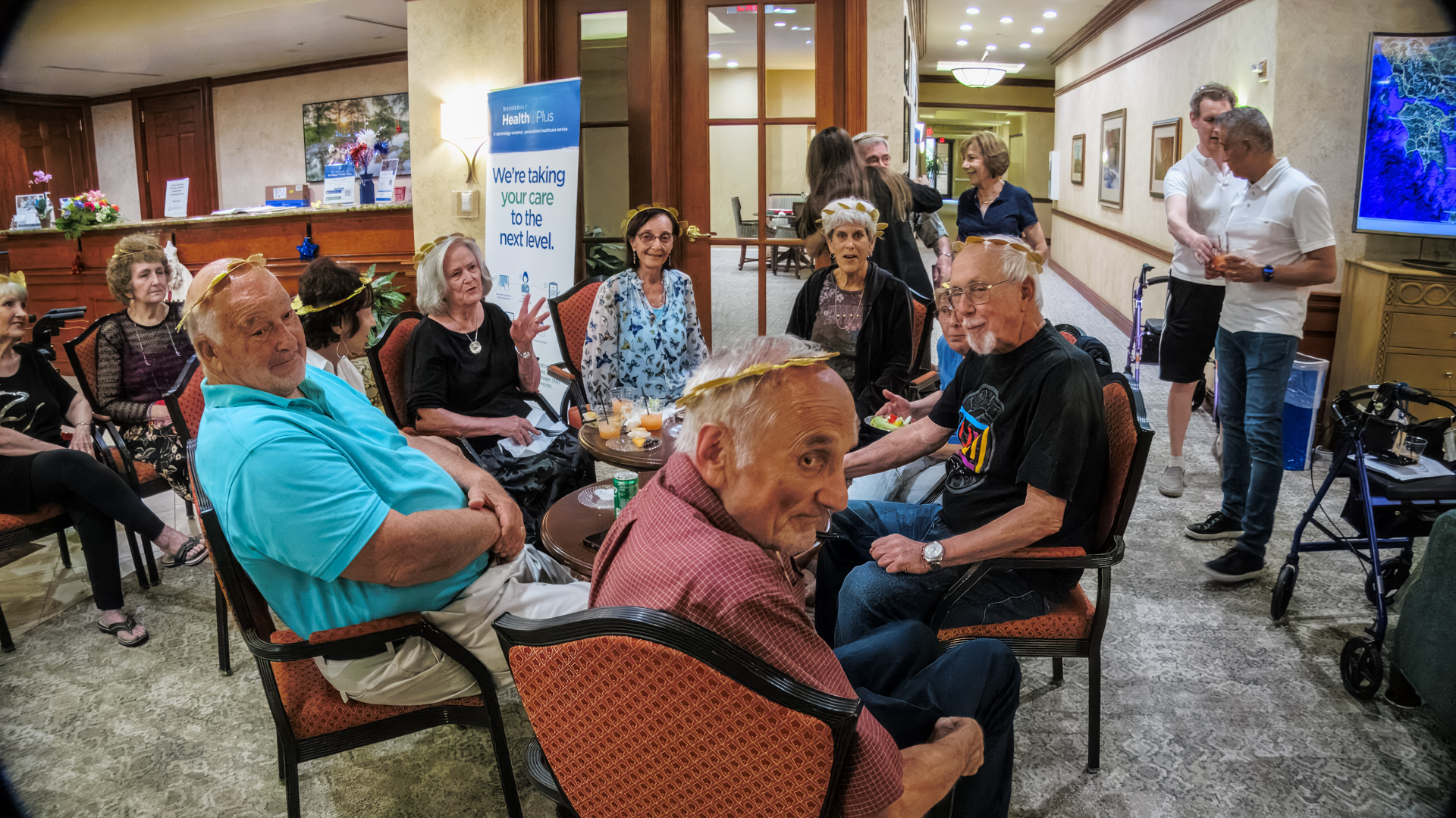 Group of smiling guests seated around a small table