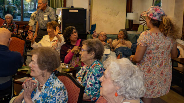 Elena takes a photo while Helen, Adele and Joyce celebrate Crowd
