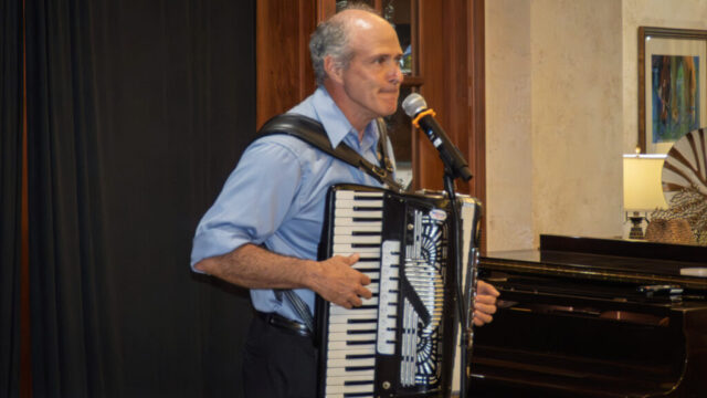Oliver serious??? Nah! Close-mouthed man playing accordion