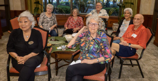Minja, Theresia, Megan, Mary Ann, Bob, Sue, Arnie Seven seated people facing camera